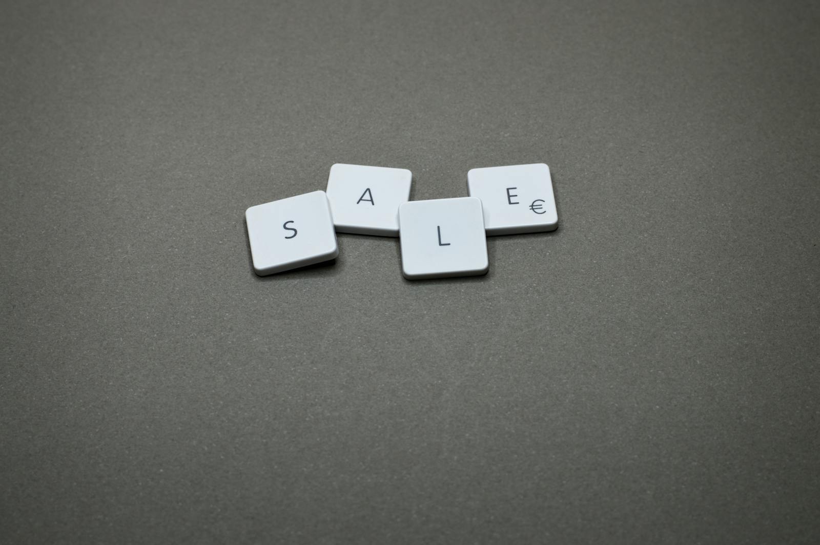 Photo by Miguel Á. Padriñán Close-up of tiles spelling 'SALE' showcasing a minimalist design theme.