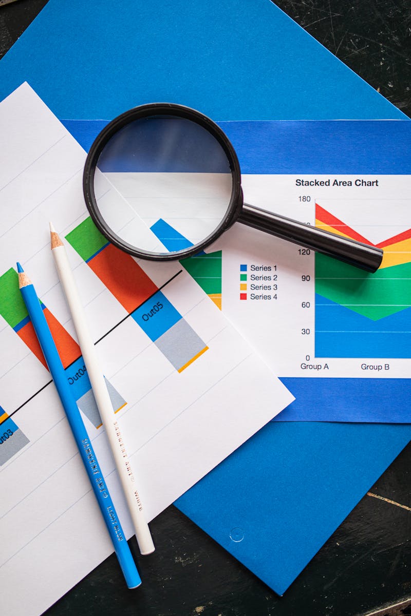 Photo by RDNE Stock project Image of financial charts and magnifying glass, ideal for business insights.