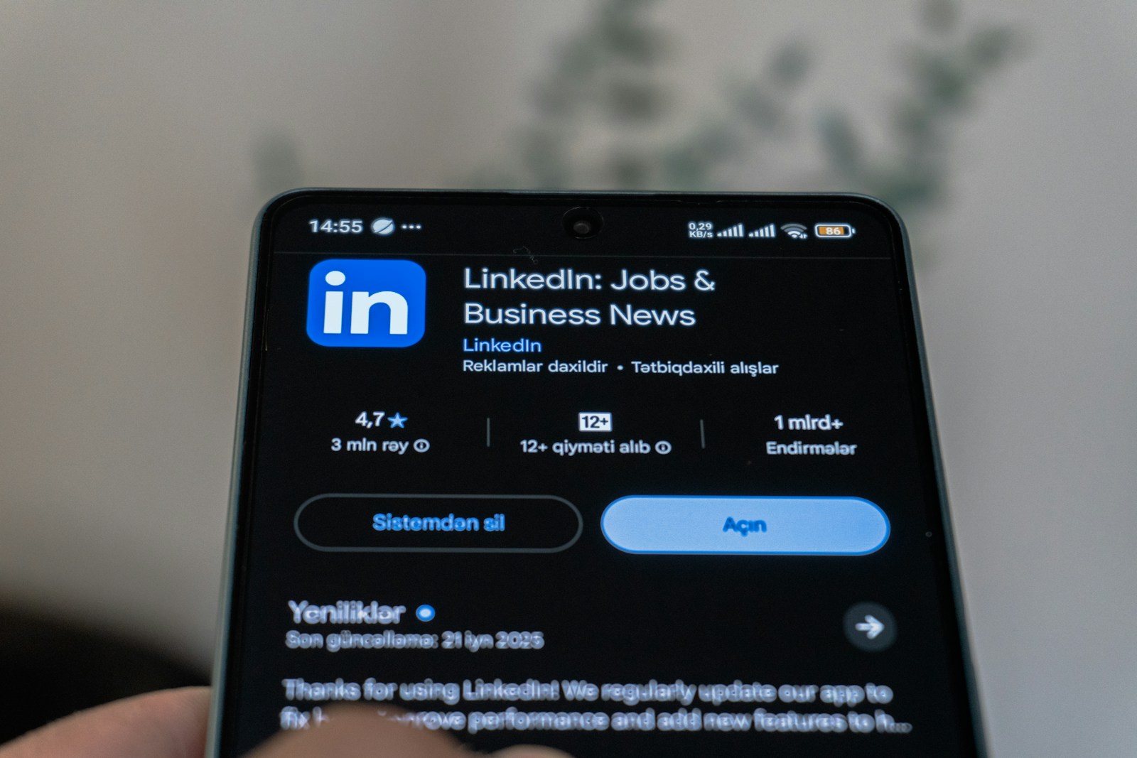 Photo by Zulfugar Karimov Linkedin app is shown on a smartphone screen.