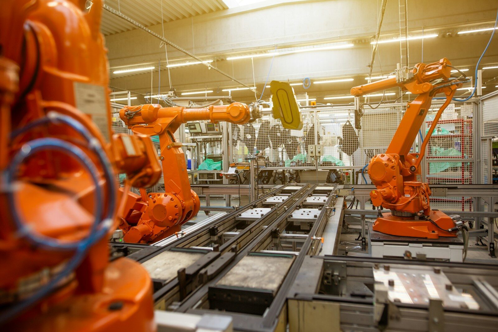Photo by Simon Kadula a factory filled with lots of orange machines